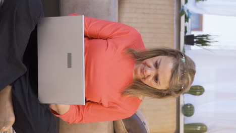 Vertical-video-of-Concentrated-woman-working-on-laptop.